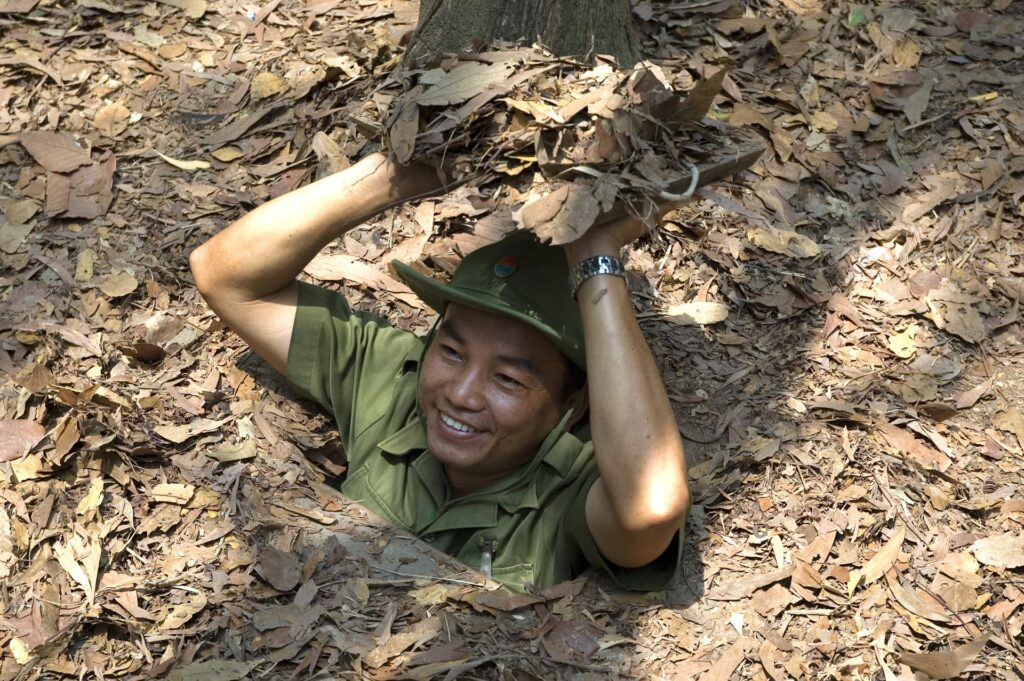 A,Guide,Demonstrating,How,A,Vietcong,Hide,Into,The,Tunnel - Fareast247