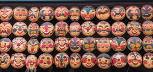Rows,Of,Hanging,Face,Painted,On,Woven,Round,Bamboo,Trays. - Fareast247