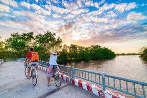 Tourist,Couple,Riding,Bicycle,In,The,Mekong,Delta,Region,,Ben - Fareast247